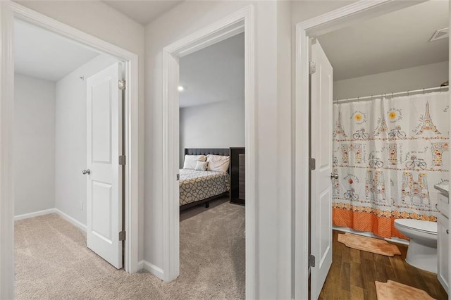 bathroom featuring curtained shower and toilet