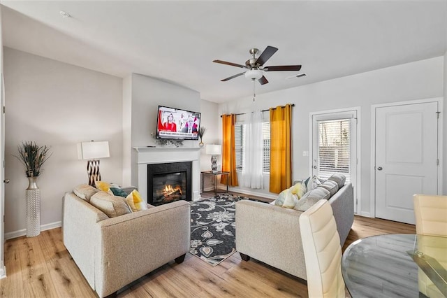 living room featuring ceiling fan and light wood-type flooring