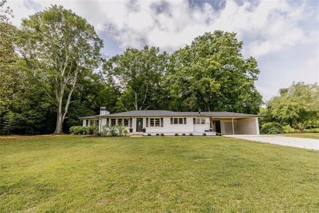 1233 Bethlehem Rd, Statham, GA 30666 - ranch-style house featuring driveway, an attached carport, a front lawn, and a chimney