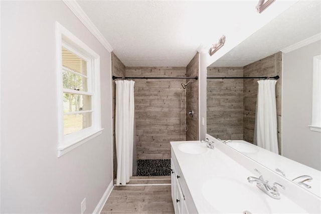 1233 Bethlehem Rd, Statham, GA 30666 - bathroom featuring ornamental molding, wood finished floors, a tile shower, and double vanity