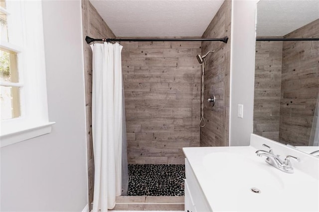 1233 Bethlehem Rd, Statham, GA 30666 - bathroom featuring a stall shower, vanity, and a textured ceiling