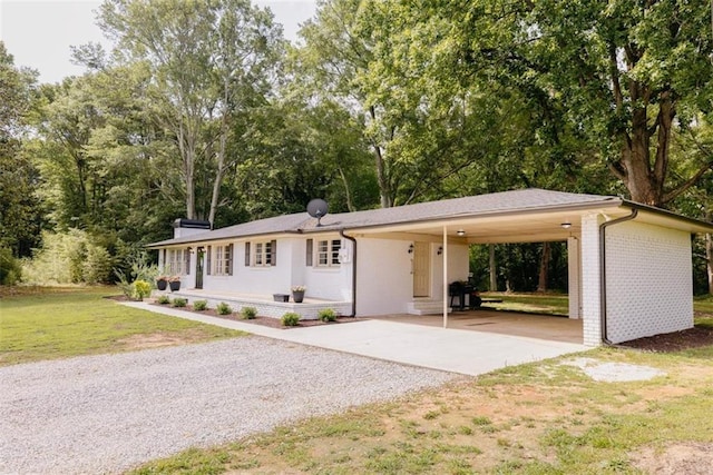 1233 Bethlehem Rd, Statham, GA 30666 - ranch-style home featuring driveway, a front yard, an attached carport, and brick siding