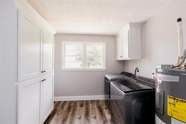 1233 Bethlehem Rd, Statham, GA 30666 - washroom featuring electric water heater, cabinet space, dark wood-style floors, a textured ceiling, and separate washer and dryer