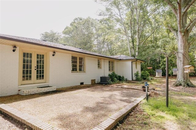 1233 Bethlehem Rd, Statham, GA 30666 - back of house with brick siding, central air condition unit, and french doors