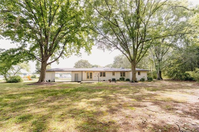 1233 Bethlehem Rd, Statham, GA 30666 - back of house featuring a lawn