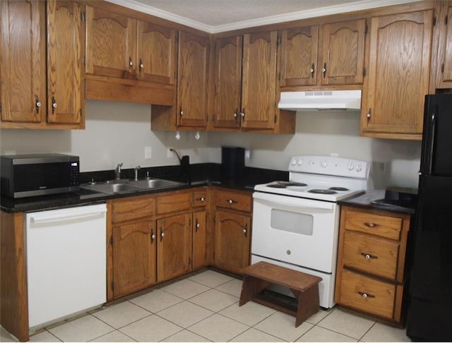 kitchen featuring a sink, dark countertops, white appliances, and under cabinet range hood