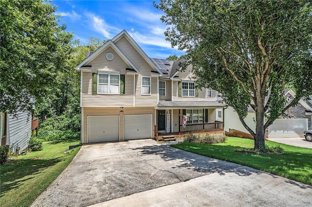 view of front of house with a front yard, a garage, and a porch