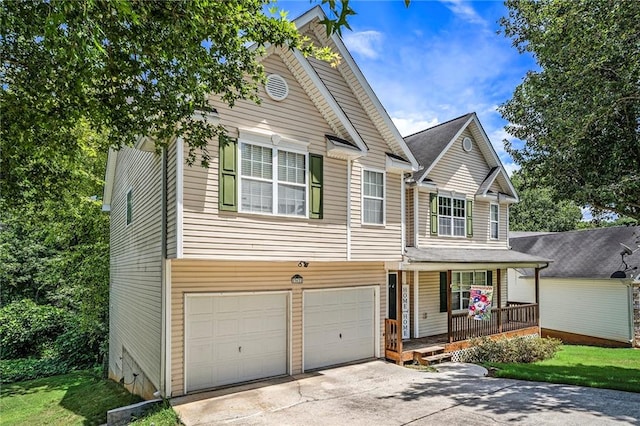 view of front facade with a front yard, a garage, and a porch