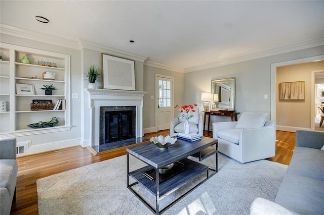 2007 Mount Vernon Pl, Dunwoody, GA 30338 - living area featuring crown molding, wood finished floors, a fireplace, and built in shelves