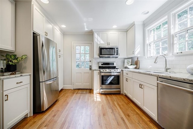 2007 Mount Vernon Pl, Dunwoody, GA 30338 - kitchen featuring appliances with stainless steel finishes, white cabinets, tasteful backsplash, ornamental molding, and recessed lighting