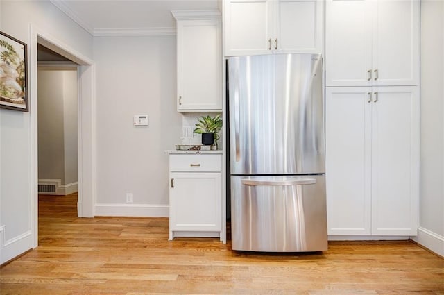 2007 Mount Vernon Pl, Dunwoody, GA 30338 - kitchen with freestanding refrigerator, light wood-style flooring, white cabinets, ornamental molding, and light stone countertops