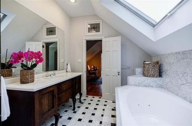 2007 Mount Vernon Pl, Dunwoody, GA 30338 - full bath featuring a skylight, vaulted ceiling, a jetted tub, and vanity