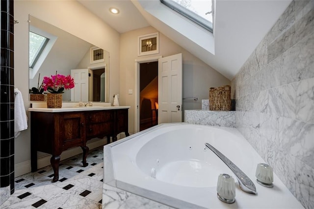 2007 Mount Vernon Pl, Dunwoody, GA 30338 - bathroom featuring a skylight, a jetted tub, vaulted ceiling, vanity, and recessed lighting