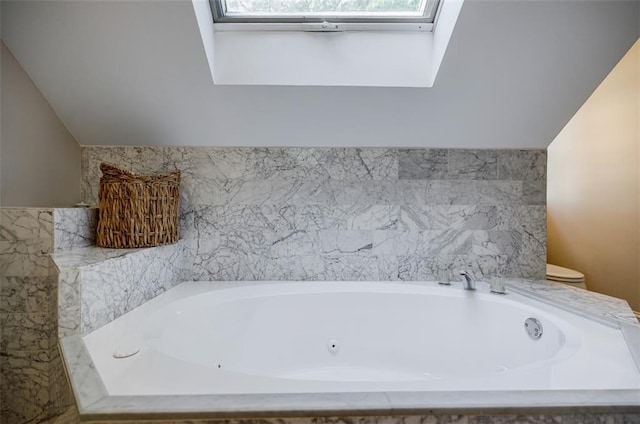 2007 Mount Vernon Pl, Dunwoody, GA 30338 - bathroom with a jetted tub, lofted ceiling, and a skylight