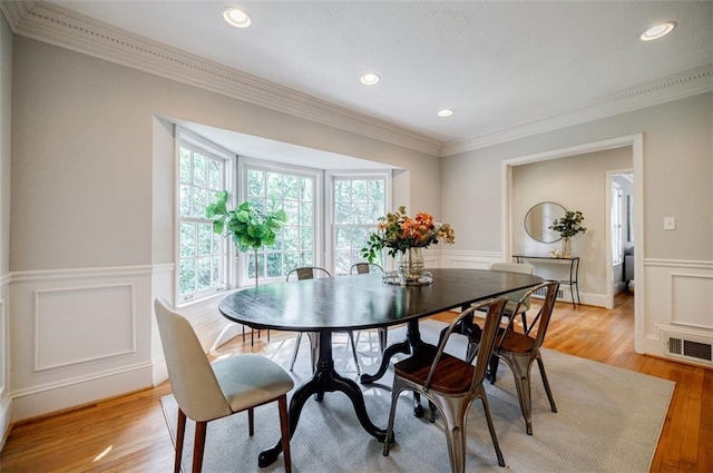 2007 Mount Vernon Pl, Dunwoody, GA 30338 - dining space with crown molding, wainscoting, light wood-type flooring, a decorative wall, and recessed lighting