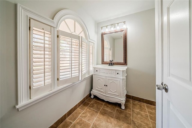 bathroom with vanity and baseboards