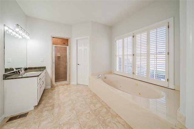 full bathroom featuring visible vents, a tub with jets, a stall shower, and vanity