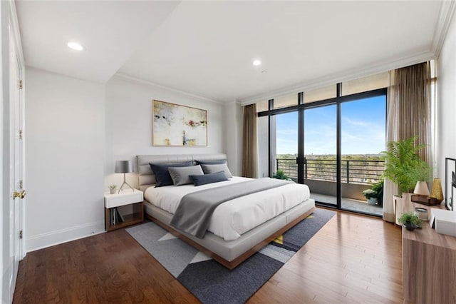 bedroom with crown molding, a wall of windows, access to exterior, and hardwood / wood-style floors