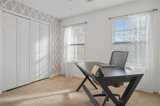 office area featuring light carpet, wallpapered walls, baseboards, and a textured ceiling