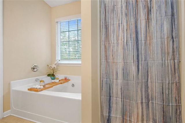 bathroom featuring a shower with curtain, tile patterned floors, baseboards, and a bath