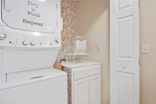 washroom with laundry area and stacked washer / dryer