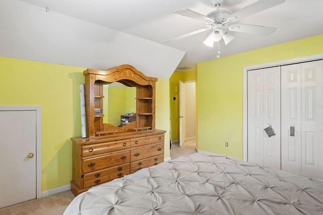 carpeted bedroom featuring ceiling fan and a closet