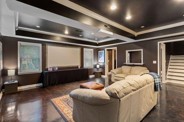 home theater with a raised ceiling and ornamental molding