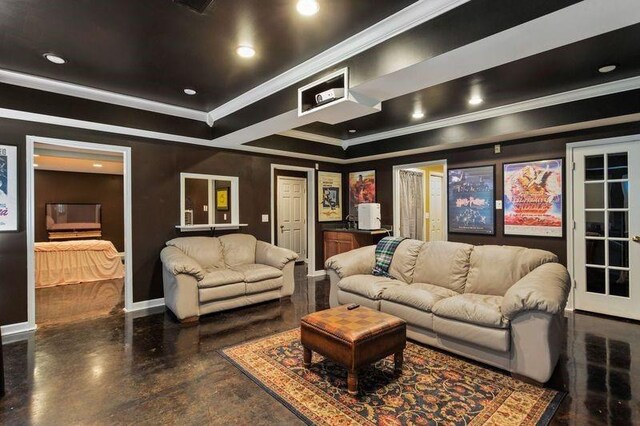 home theater room featuring a tray ceiling and crown molding