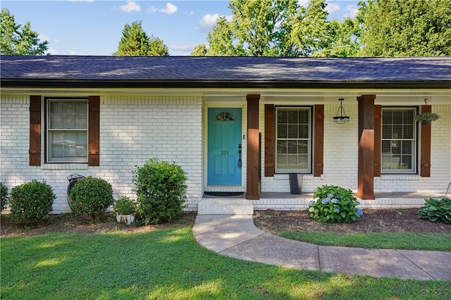 view of front of property with a front yard and a porch