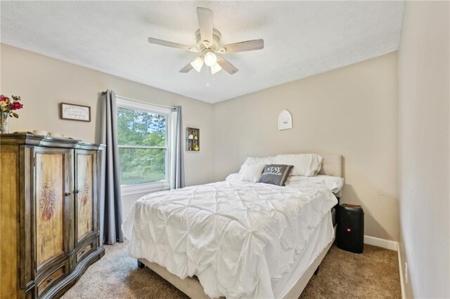 bedroom with carpet, baseboards, and ceiling fan