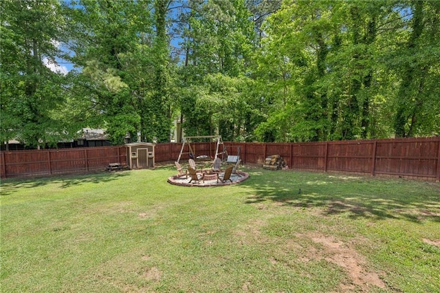 view of yard with a shed, an outdoor fire pit, and an outbuilding