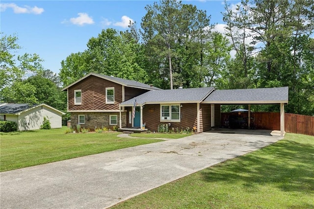 tri-level home featuring concrete driveway and a carport