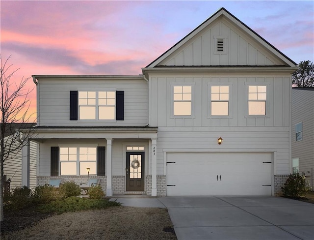 view of front of home with a porch and a garage