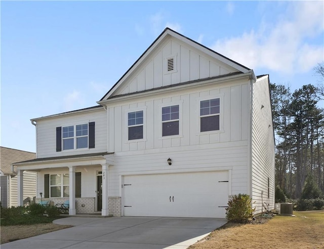 view of front of home featuring a porch, a garage, and central AC