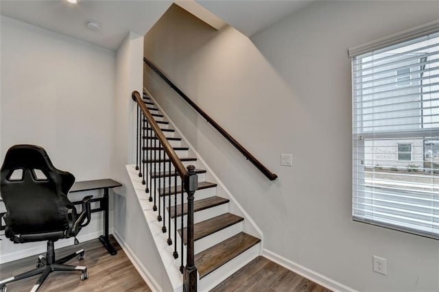 stairs featuring hardwood / wood-style floors