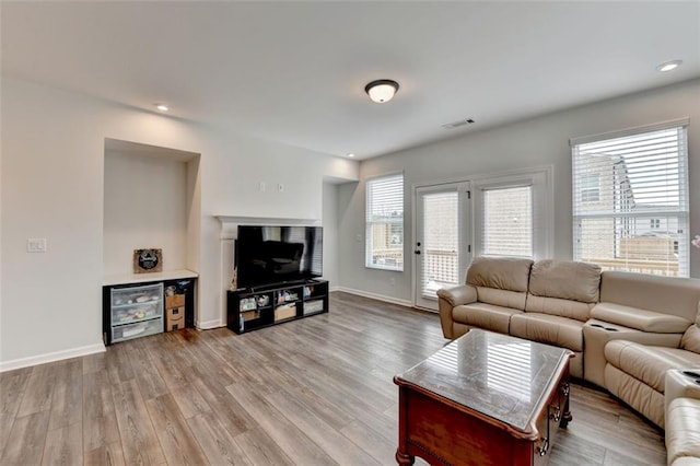 living room featuring light hardwood / wood-style flooring and plenty of natural light