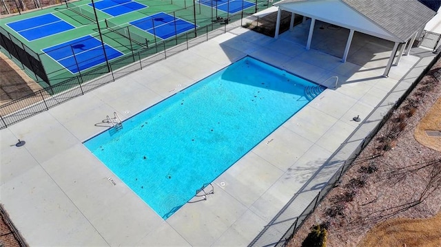 view of pool featuring tennis court