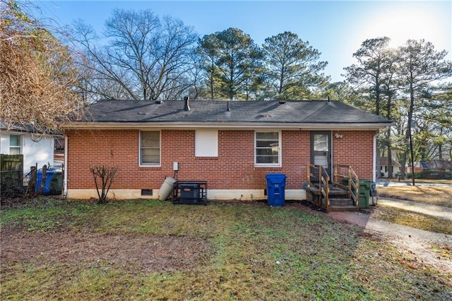 rear view of house with a yard