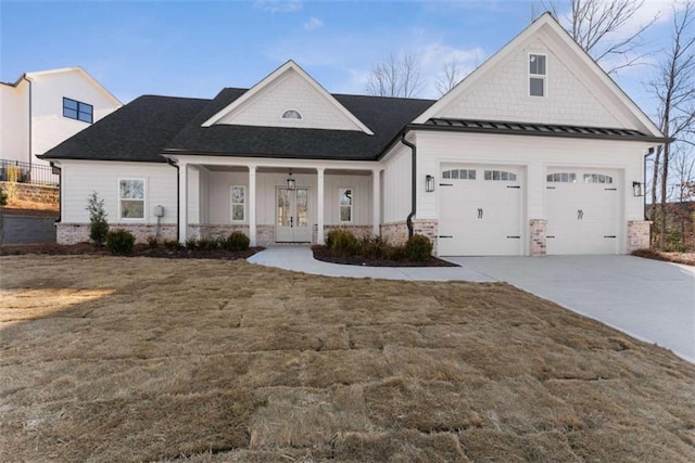 view of front of property with metal roof, an attached garage, concrete driveway, a standing seam roof, and a front yard