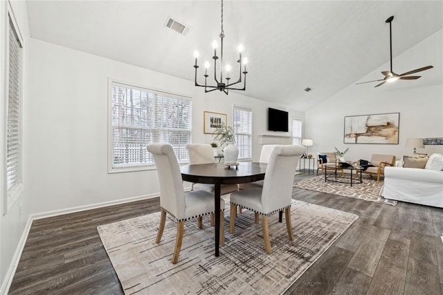 dining space featuring high vaulted ceiling, wood-type flooring, and ceiling fan with notable chandelier