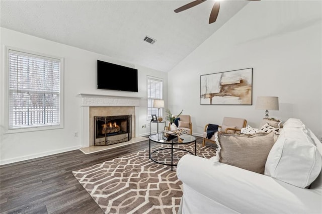 living room with ceiling fan, a fireplace, plenty of natural light, and dark hardwood / wood-style flooring