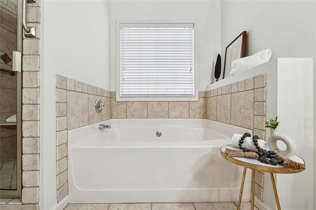 bathroom with a bathing tub and tile patterned flooring