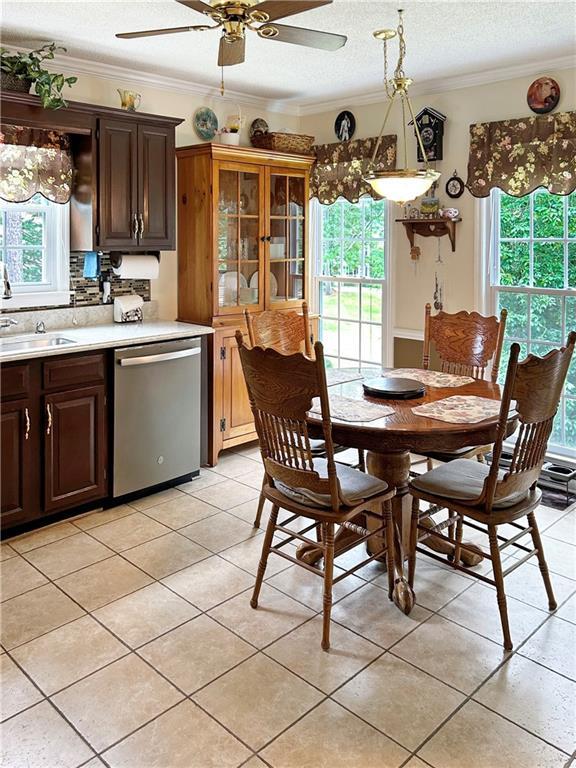 21 Picketts Ridge Ln, Acworth, GA 30101 - dining area with a textured ceiling, light tile patterned flooring, ornamental molding, and a ceiling fan