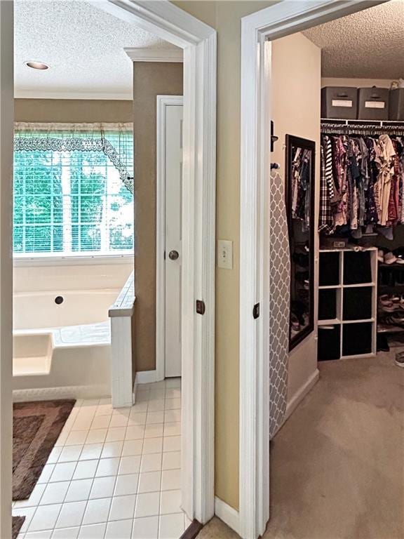 21 Picketts Ridge Ln, Acworth, GA 30101 - full bath featuring a textured ceiling, a garden tub, a spacious closet, tile patterned flooring, and crown molding
