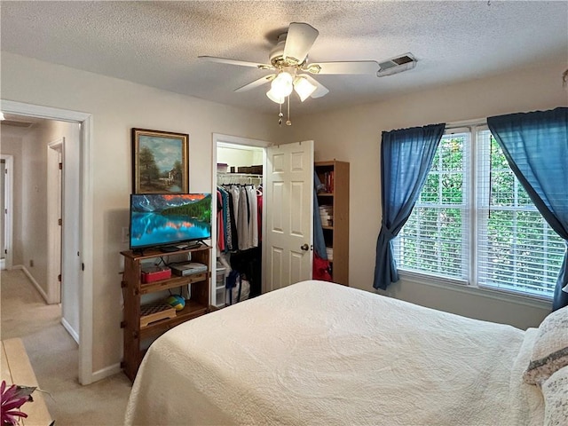 21 Picketts Ridge Ln, Acworth, GA 30101 - bedroom featuring light colored carpet, a textured ceiling, baseboards, a closet, and a walk in closet