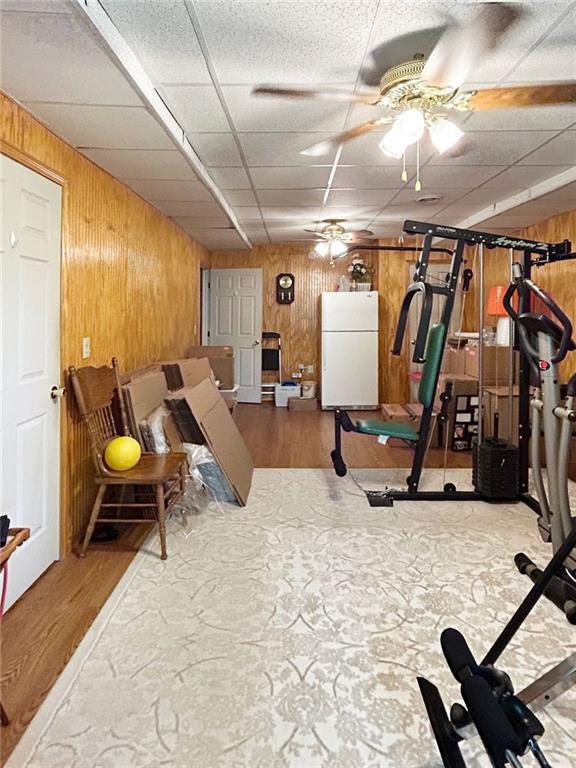21 Picketts Ridge Ln, Acworth, GA 30101 - exercise room with a ceiling fan, wood walls, a paneled ceiling, and wood finished floors