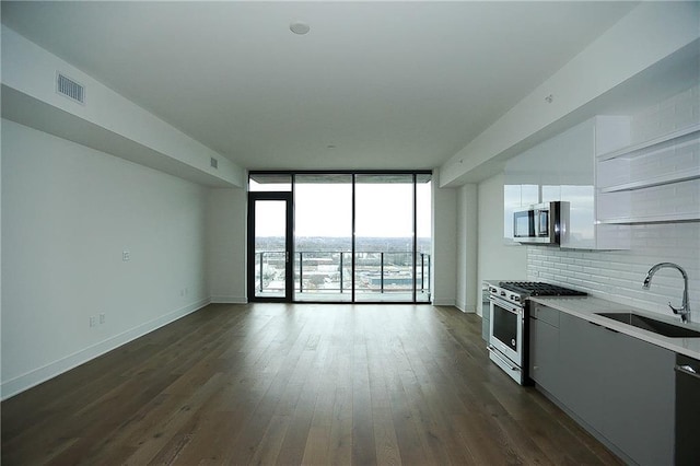 788 W Marietta St NW Unit 811, Atlanta, GA 30318 - kitchen featuring appliances with stainless steel finishes, a sink, tasteful backsplash, open floor plan, and dark wood-style flooring