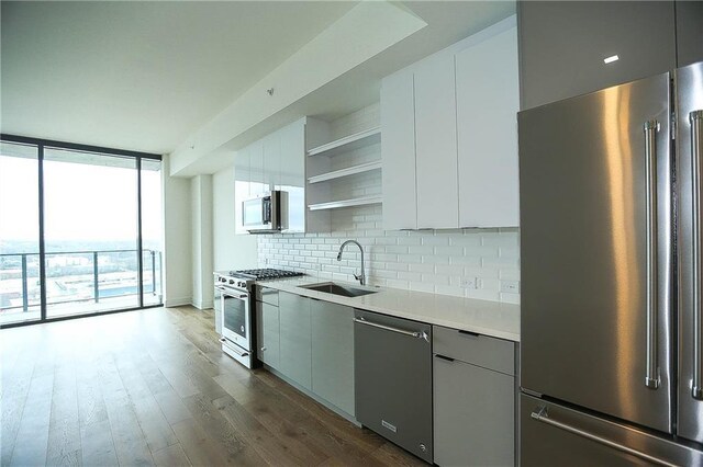 788 W Marietta St NW Unit 811, Atlanta, GA 30318 - kitchen with high quality appliances, a sink, open shelves, backsplash, and light countertops