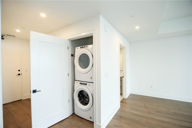 788 W Marietta St NW Unit 811, Atlanta, GA 30318 - clothes washing area featuring stacked washer and clothes dryer, wood finished floors, recessed lighting, and baseboards