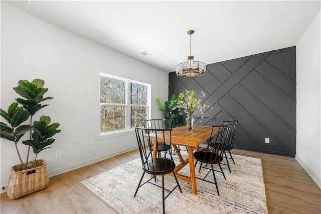 dining room featuring a chandelier and light hardwood / wood-style flooring